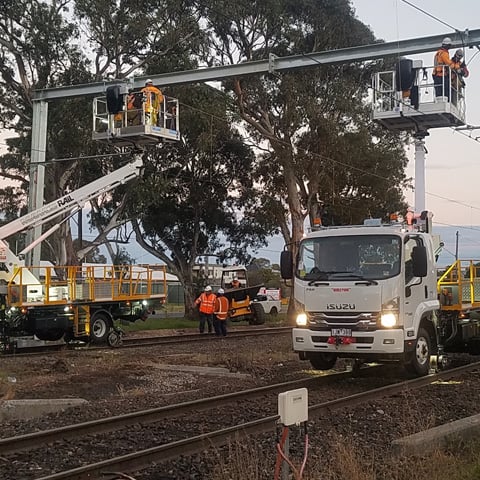 Bucket Truck on Train Tracks with hi-rail electrification operators